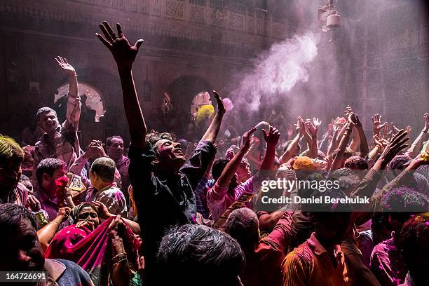 Hindu devotees play with colour during Holi celebrations at the Banke Bihari temple on March 27, 2013 in Vrindavan, India. The tradition of playing...