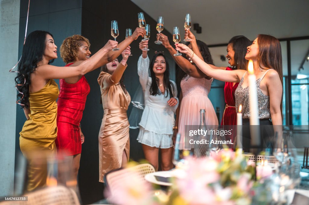 Happy Diverse Women Raising a Glass to Friend's Engagement