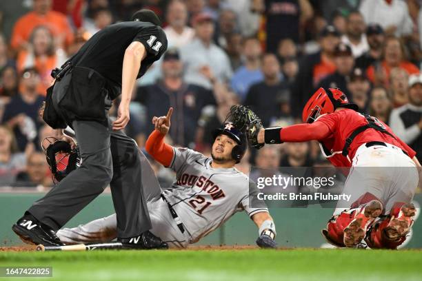 Yainer Diaz of the Houston Astros slides safely into home on a two-run RBI hit by Mauricio Dubon during the sixth inning of a game against the Boston...