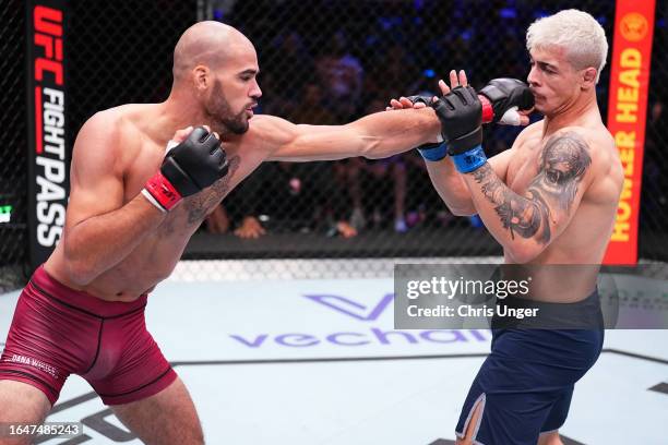 Yousri Belgaroui of The Netherlands punches Marco Tulio of Brazil in their middleweight fight during Dana White's Contender Series season seven, week...