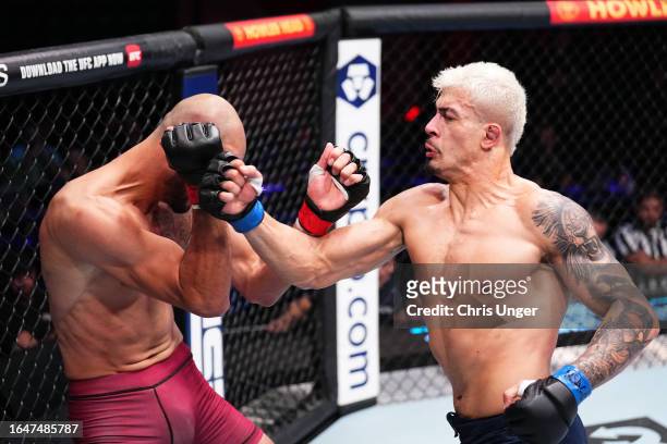 Marco Tulio of Brazil punches Yousri Belgaroui of The Netherlands in their middleweight fight during Dana White's Contender Series season seven, week...