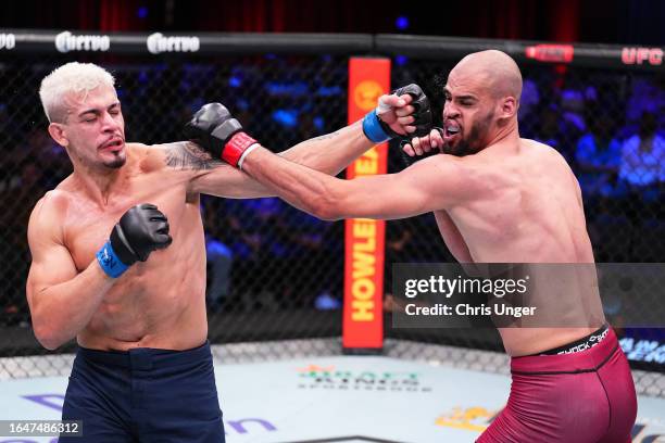 Marco Tulio of Brazil punches Yousri Belgaroui of The Netherlands in their middleweight fight during Dana White's Contender Series season seven, week...