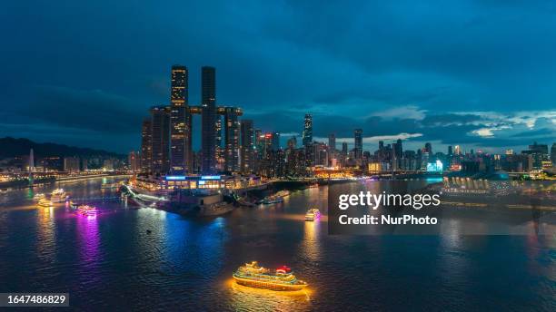 Tourists enjoy the night view of two rivers and four banks on a cruise ship in Chongqing, China, Aug. 3, 2023. According to the data disclosed by...