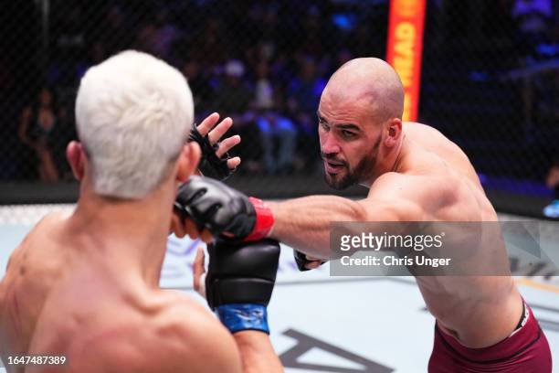 Yousri Belgaroui of The Netherlands punches Marco Tulio of Brazil in their middleweight fight during Dana White's Contender Series season seven, week...