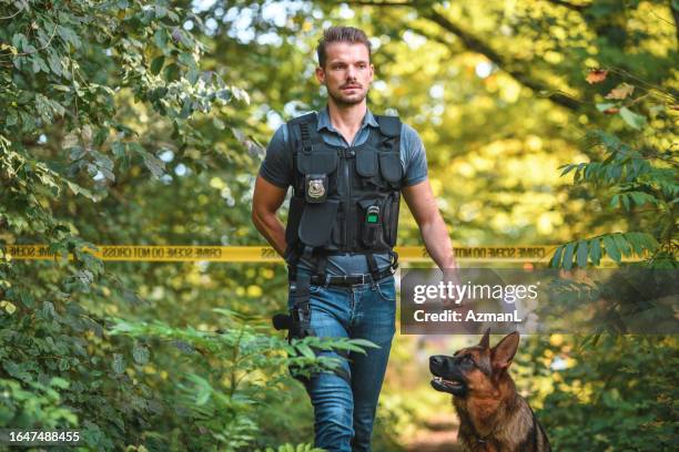 correctional officer and police dog approaching a  crime scene in the woods - correctional officer stock pictures, royalty-free photos & images