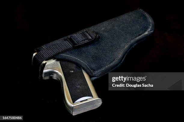 handgun type automatic pistol in a holster - gun holster stock pictures, royalty-free photos & images