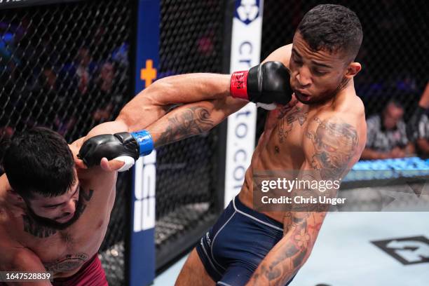 Mitch Ramirez punches Carlos Prates of Brazil in their welterweight fight during Dana White's Contender Series season seven, week four at UFC APEX on...