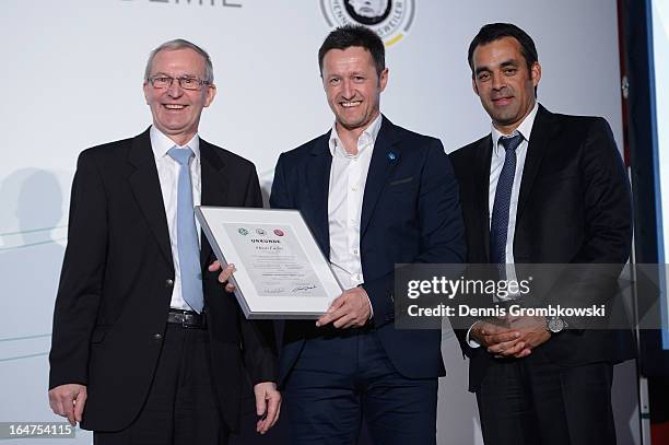 Henri Fuchs is honoured by Rainer Milkoreit and Robin Dutt during the Coaching and Technichal Development Course Awarding Ceremony on March 27, 2013...