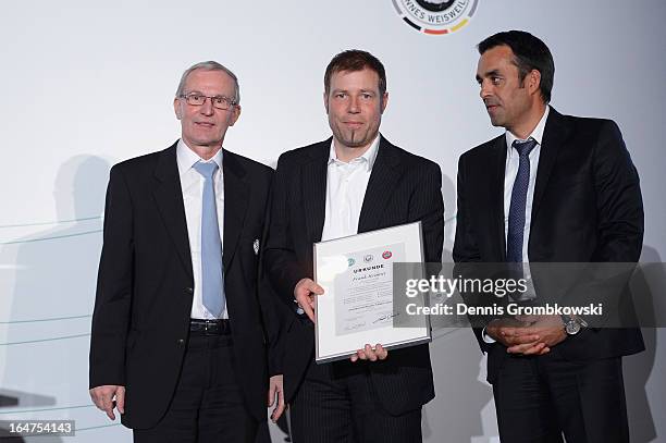 Frank Kramer is honoured by Rainer Milkoreit and Robin Dutt during the Coaching and Technichal Development Course Awarding Ceremony on March 27, 2013...