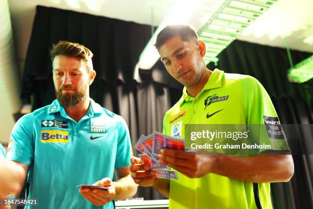 Jason Sangha of the Thunder and Michael Neser of the Heat look at trading cards during the Big Bash League Draft Launch at Micdrop on August 30, 2023...