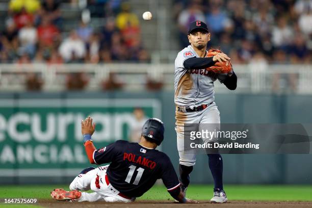 Jorge Polanco of the Minnesota Twins is forced out at second base as Andres Gimenez of the Cleveland Guardians turns a double play in the seventh...