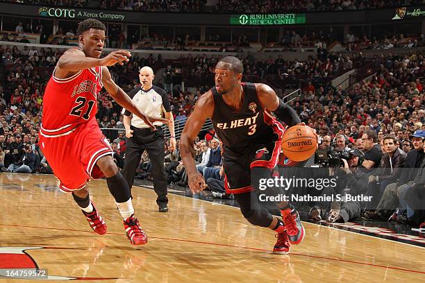 Dwyane Wade of the Miami Heat drives past Jimmy Butler of the Chicago Bulls on March 27, 2013 at the United Center in Chicago, Illinois. NOTE TO...