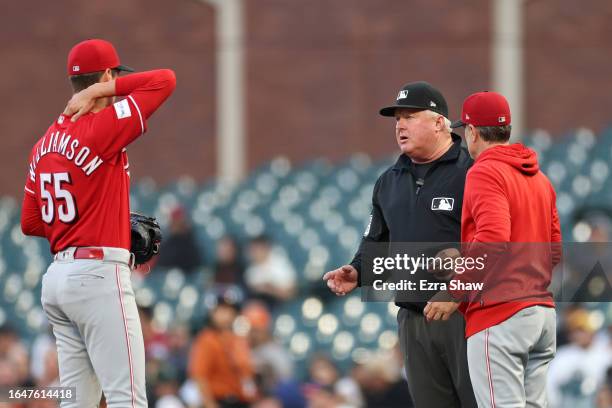 First base umpire Bill Miller talks to Brandon Williamson and manager David Bell after Williamson was called for a balk that scored a run for the San...