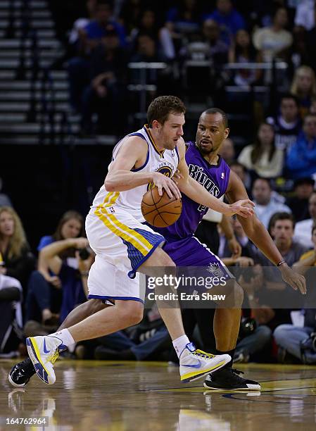 David Lee of the Golden State Warriors drives on Chuck Hayes of the Sacramento Kings at Oracle Arena on March 27, 2013 in Oakland, California. NOTE...