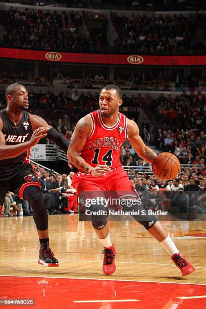 Daequan Cook of the Chicago Bulls drives on Dwyane Wade of the Miami Heat on March 27, 2013 at the United Center in Chicago, Illinois. NOTE TO USER:...