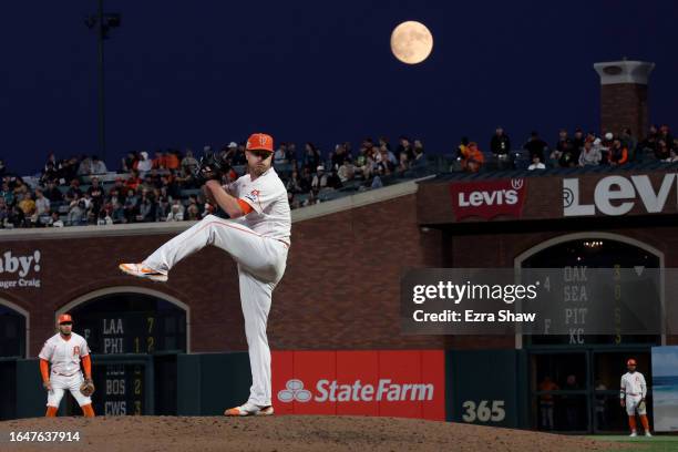 Alex Cobb of the San Francisco Giants pitches against the Cincinnati Reds as a almost full moon rises behind him in the fifth inning at Oracle Park...