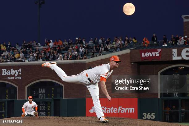 Alex Cobb of the San Francisco Giants pitches against the Cincinnati Reds as a almost full moon rises behind him in the fifth inning at Oracle Park...