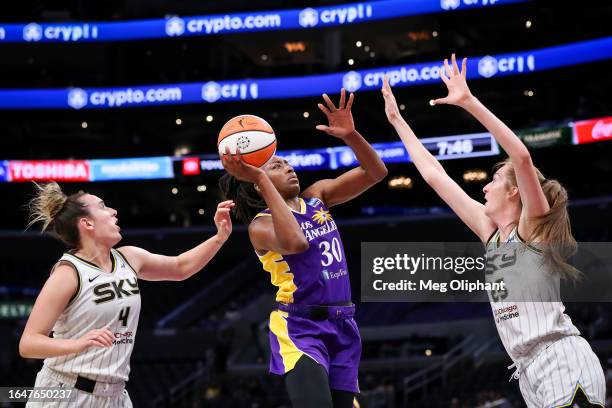 Forward Nneka Ogwumike of the Los Angeles Sparks shoots defended by guard Marina Mabrey and forward Morgan Bertsch of the Chicago Sky in the first...