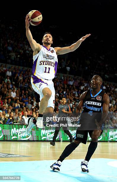 Aaron Bruce of the Kings lays up the ball over the top of Cedric Jackson of the Breakers during game one of the NBL Semi Final series between the New...