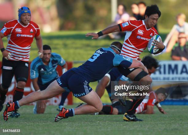 Yoshitaka Tokunaga of Japan is tackled during the Pacific Rugby Cup match between the Blues Development and Junior Japan at Bell Park on March 28,...