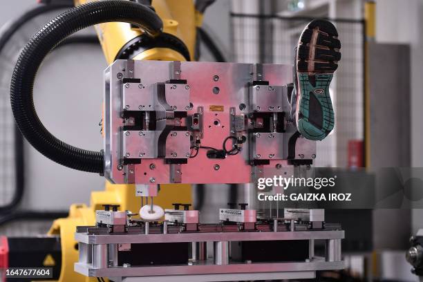 Photograph taken in Hendaye, southwestern France, on September 4, 2023 shows a machine removing an old shoe at CETIA, the very first innovation...