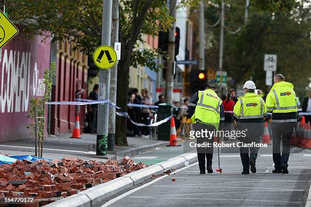Work Safe investigators are seen at the scene of a wall collapse on March 28, 2013 in Melbourne, Australia. Police have confirmed three people have...