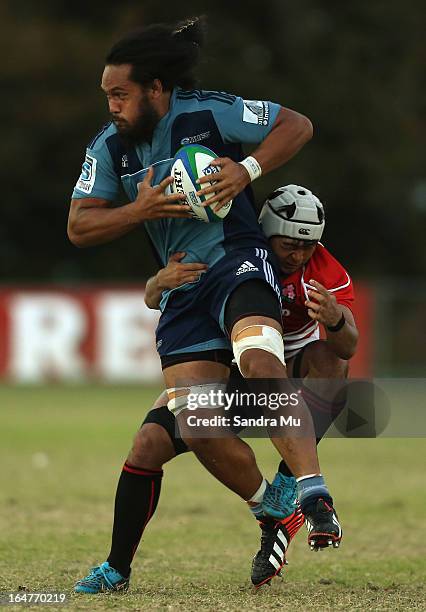 Liaki Moli of the Blues is tackled by Hayato Nishiuchi of Japan during the Pacific Rugby Cup match between the Blues Development and Junior Japan at...