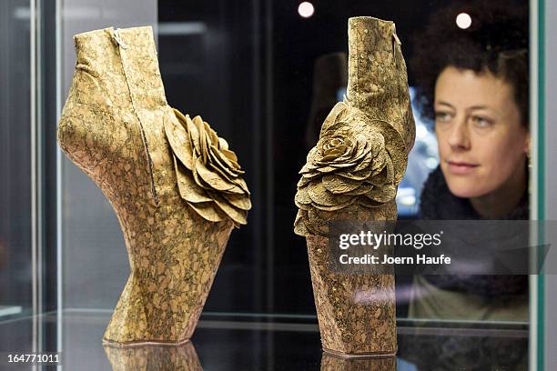 Visitor looks at a pair of shoes with the name 'Nature Extends' designed for Lady Gaga by Jantaminiau at the exhibition: 'Starker Auftritt:...