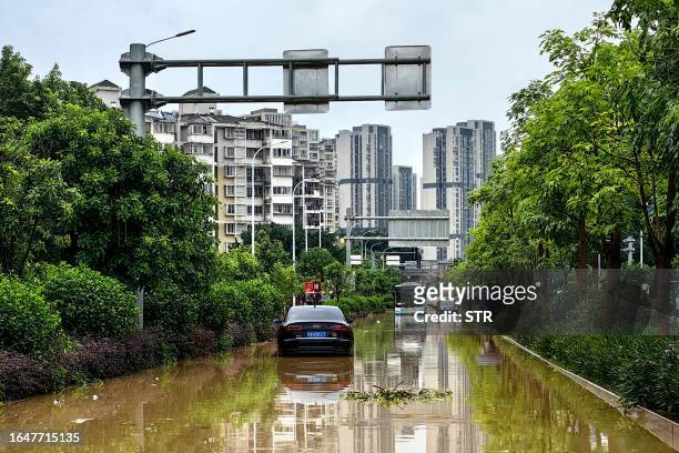 Stranded cars are seen along a flooded street after heavy rains caused by Typhoon Haikui in Fuzhou, in China's southern Fujian province on September...