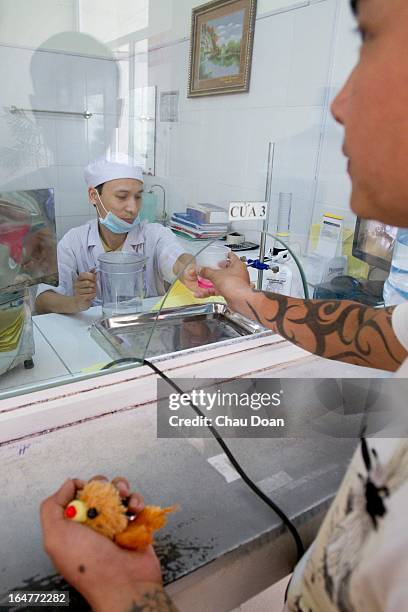 Health worker gives drug addicts their daily methadone dose at the Long Bien District Health Center. Vietnam has many comprehensive health programs...