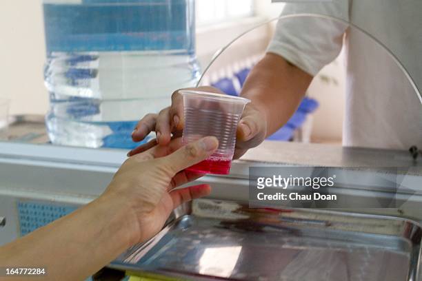 Drug addict gets his daily methadone dose at the Long Bien District Health Center. Vietnam has many comprehensive health programs aimed at the...