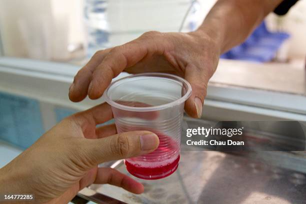 Drug addict gets his daily methadone dose at the Long Bien District Health Center. Vietnam has many comprehensive health programs aimed at the...