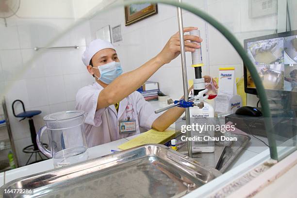 Health worker gives drug addicts their daily methadone dose at the Long Bien District Health Center. Vietnam has many comprehensive health programs...