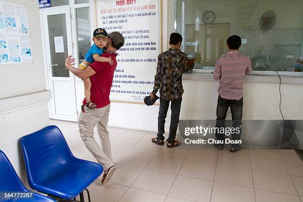 Drug addict leaves with his son after getting his daily methadone dose at the Long Bien District Health Center. Vietnam has many comprehensive health...