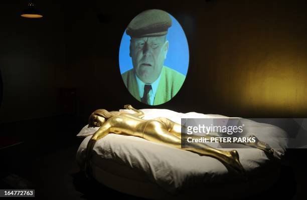 Gold painted model of a Bond girl from the James Bond movie Goldfinger is seen at an exhibition on the fictional British spy in Shanghai on March 28,...