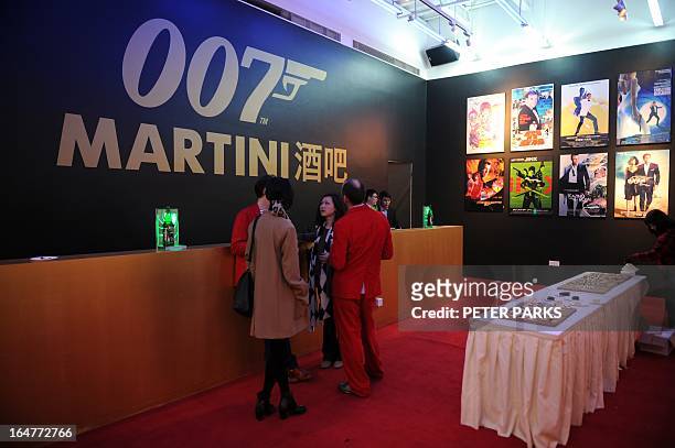 Guests drink at the Martini Bar at an exhibition on the fictional British spy James Bond in Shanghai on March 28, 2013. The exhibition opened in...