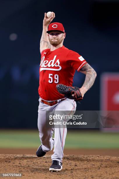 Ben Lively of the Cincinnati Reds throws a warm up pitch between innings of the game against the Arizona Diamondbacks at Chase Field on August 26,...