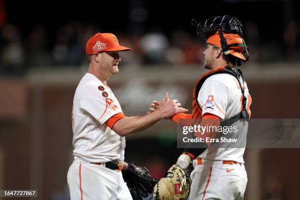 Catcher Patrick Bailey congratulates Alex Cobb of the San Francisco Giants after Cobb pitched a 1-hitter against the Cincinnati Reds at Oracle Park...