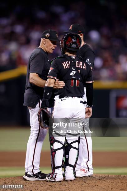 Jose Herrera of the Arizona Diamondbacks talks to pitching coach Brent Strom during the game against the Cincinnati Reds at Chase Field on August 26,...