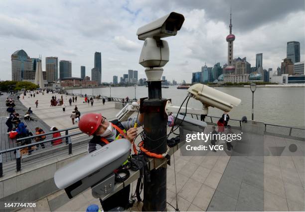 An engineer checks a device to monitor passenger flow at the Bund on March 31, 2023 in Shanghai, China.