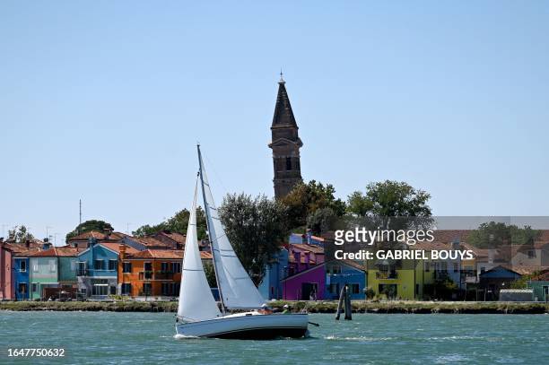Boat sails off Burano a small island of Venice lagoon, on September 5, 2023.