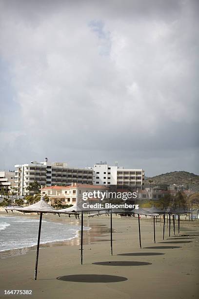 Parasols stand on an empty beach in Limassol, Cyprus, on Wednesday, March 27, 2013. The ECB said on March 25 it won't stop the Cypriot central bank...