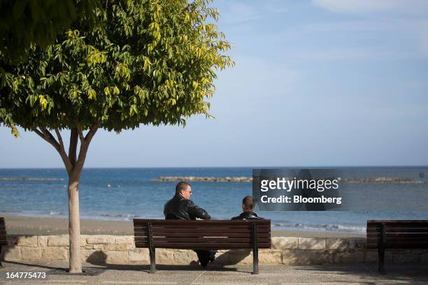 Two Russian men sit and talk on a bench by the Mediterranean sea in Limassol, Cyprus, on Wednesday, March 27, 2013. The ECB said on March 25 it won't...