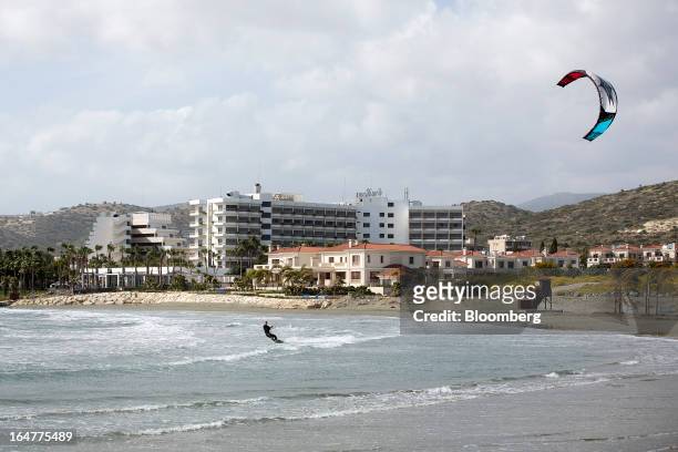 Man uses high winds to kite surf along the Mediterranean shoreline in Limassol, Cyprus, on Wednesday, March 27, 2013. The ECB said on March 25 it...