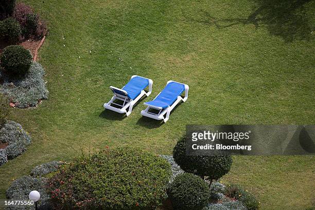 Empty sunloungers are seen in the grounds of the luxury five star St Raphael resort hotel in Limassol, Cyprus, on Wednesday, March 27, 2013. Directly...