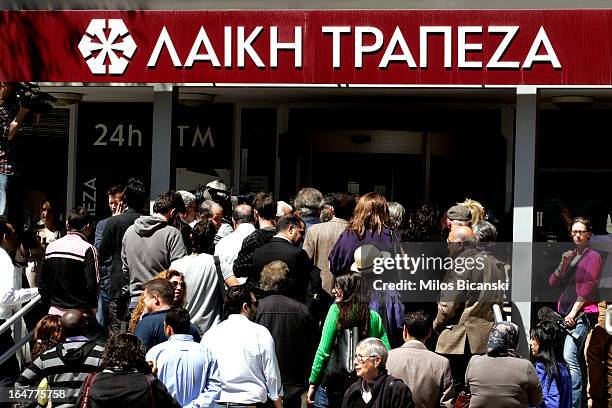 People gather in front of Laiki Bank as the country's banks re-open following 12 days of closure on March 28, 2013 in Nicosia, Cyprus. Bank trading...