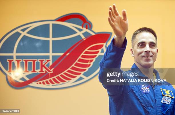 Crew member of the next expedition to the International Space Station , US astronaut Christopher Cassidy waves to relatives and friends after a press...