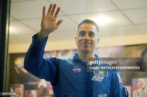 Crew member of the next expedition to the International Space Station , US astronaut Christopher Cassidy waves to relatives and friends before a...