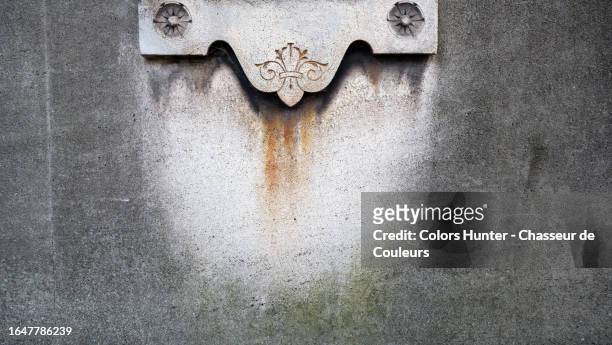 weathered gray stone wall with engraved decorations in an old style in paris, france - blank gravestone stock pictures, royalty-free photos & images