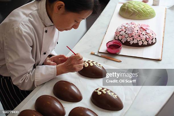 Head chocolatier Chika Watanabe creates handmade Easter eggs in the 'Melt' chocolate shop in Notting Hill on March 28, 2013 in London, England....